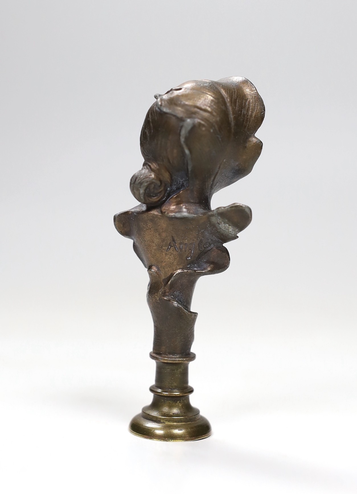 An Art Nouveau bust seal, signed Anglos, 10cm